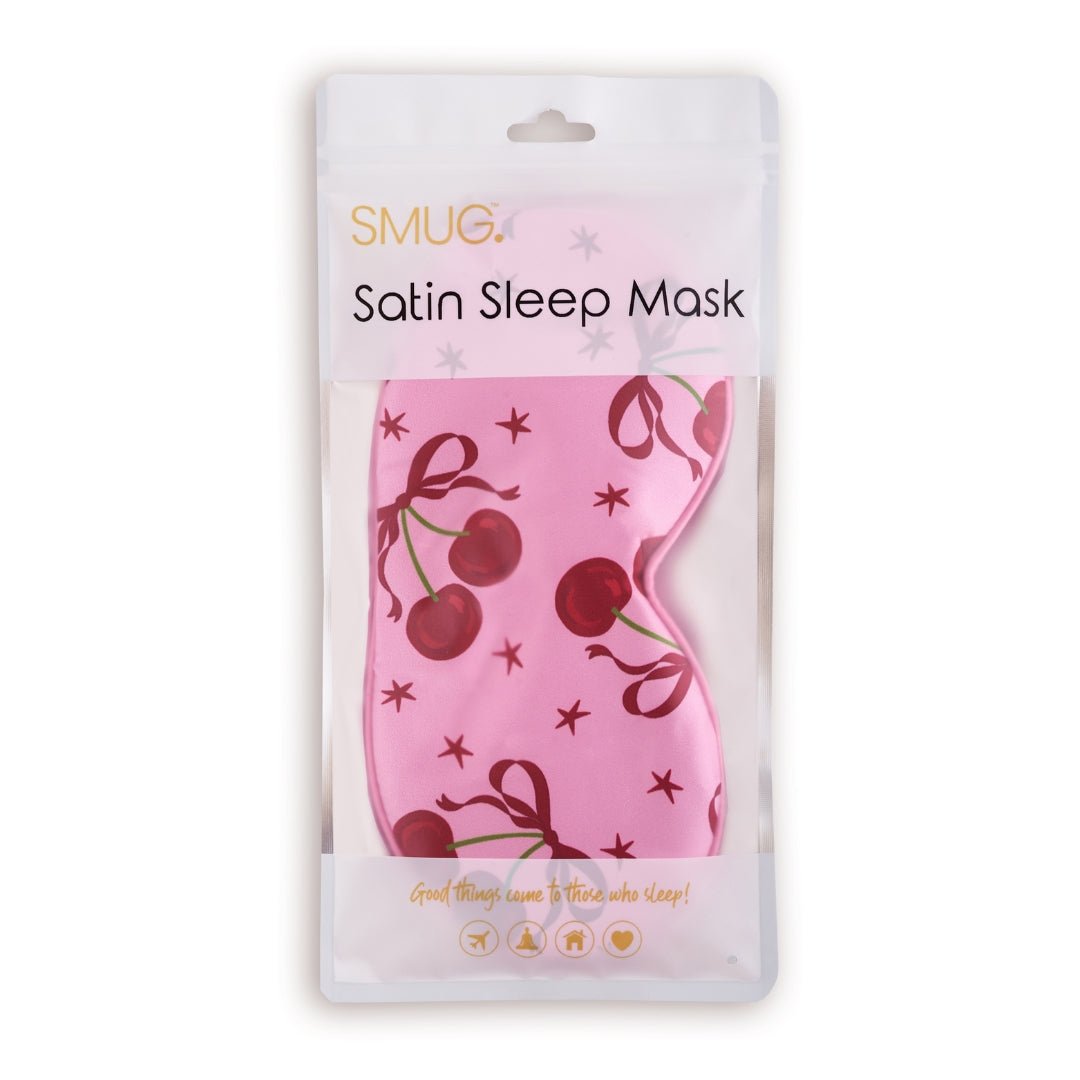 Pink satin sleep mask with cherry print by SMUG, featuring a soft, luxurious fabric and decorative cherry design.