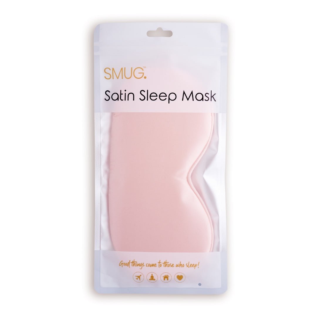 Pink satin sleep mask and pillowcase set by SMUG, featuring smooth, luxurious fabric for comfortable sleep.