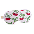 White satin sleep mask with cherry print by SMUG, soft and comfortable for restful sleep.