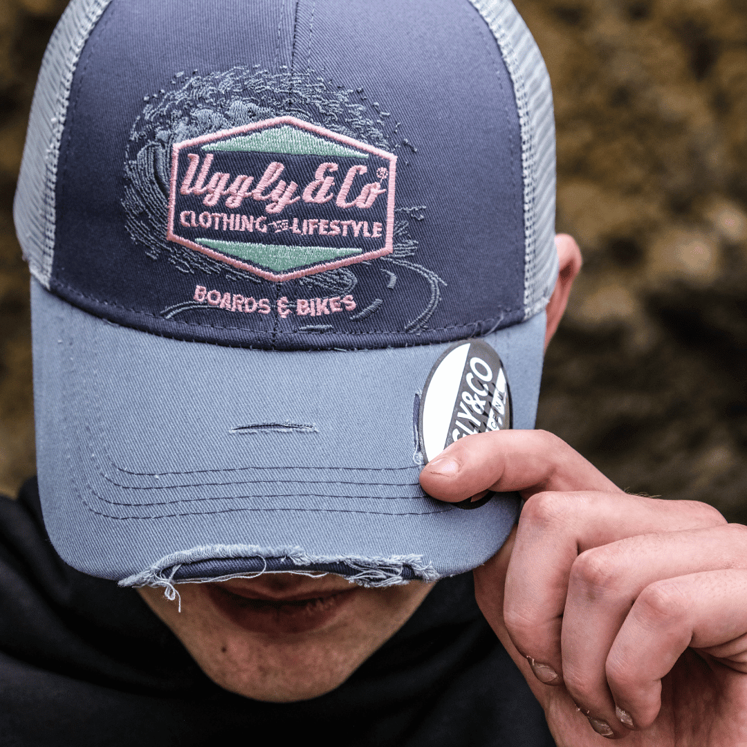 Purple surf diamond trucker cap by Uggly and Co featuring a mesh back and adjustable strap, ideal for casual beachwear.