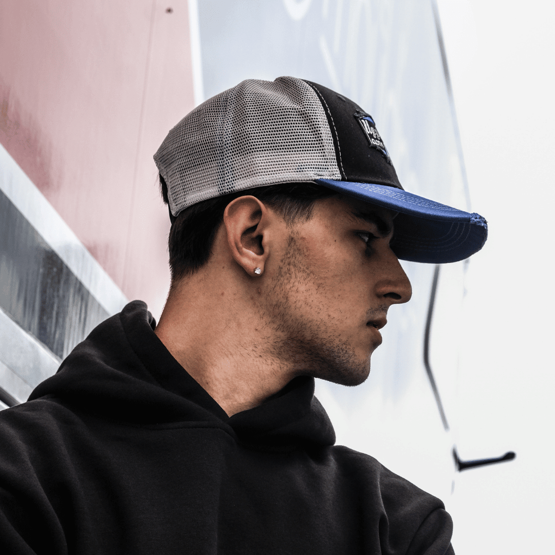 Uggly and Co diamond trucker cap featuring Cheshire Mouldings and TAS Racing logos, with mesh back and curved brim.