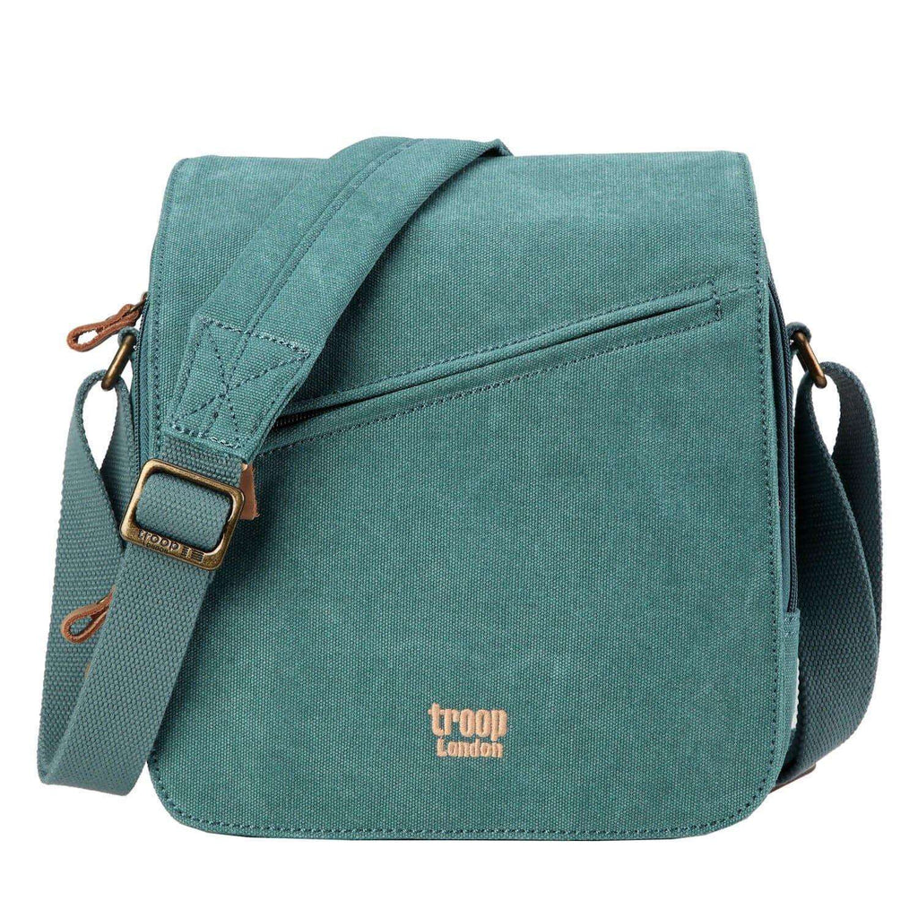 Troop London charcoal canvas crossbody bag with flap and shoulder pad, featuring adjustable strap and sleek design.
