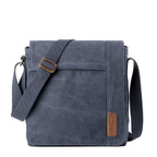 Large charcoal canvas flap crossbody bag by Troop London with adjustable strap and spacious interior.