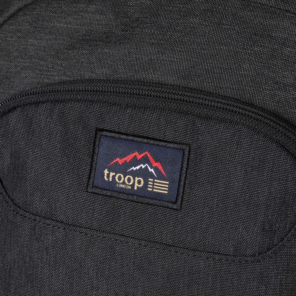 Large black Troop London Urban Daypack backpack with multiple compartments and padded straps for comfortable daily use.