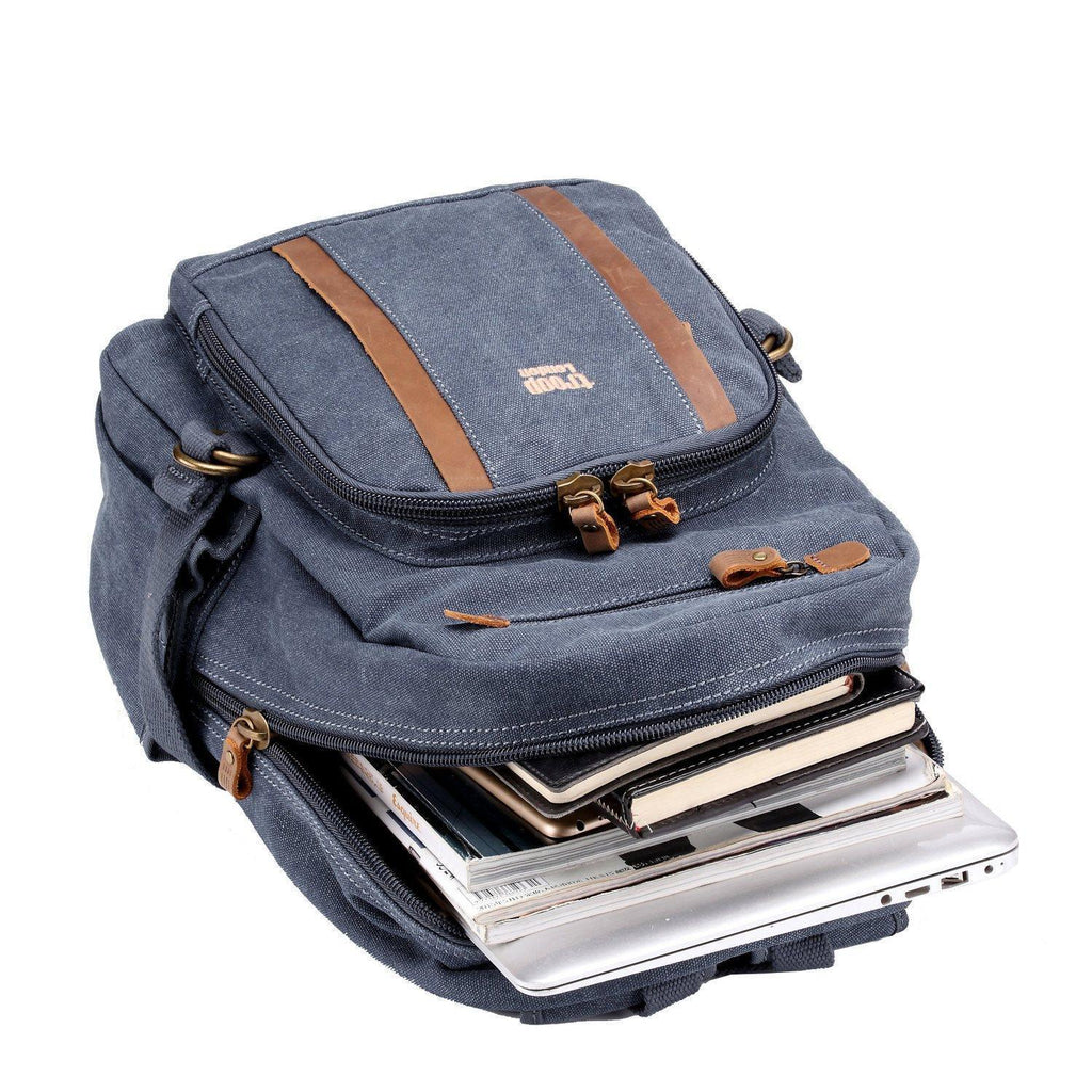 Medium blue canvas Troop London backpack with adjustable straps and front pocket, ideal for daily use and travel.