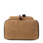 Troop London Heritage waxed canvas laptop backpack in camel, featuring multiple compartments and adjustable straps.
