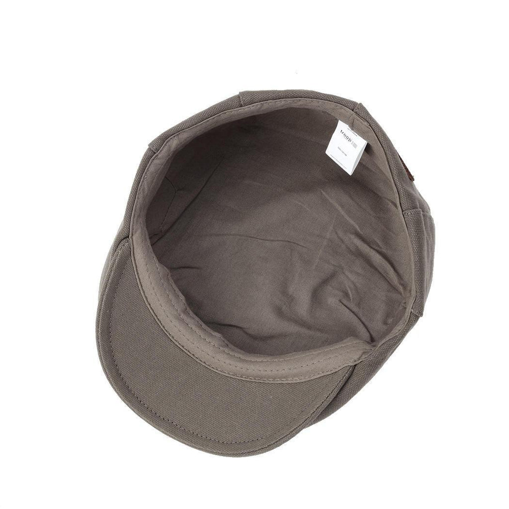 Olive waxed canvas flat cap by Troop London, stylish men's hat with classic design and durable fabric for everyday wear.