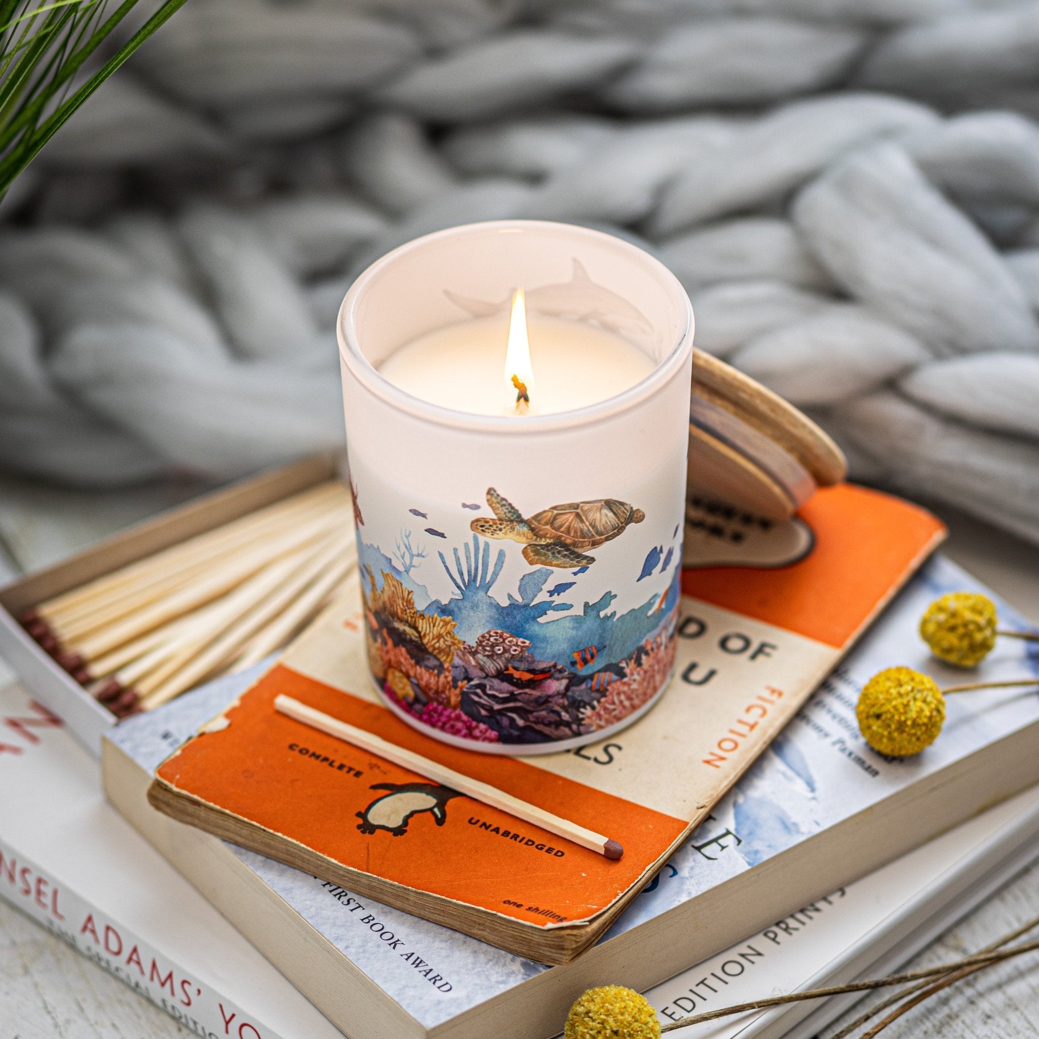Trouvaille Marine Soy Scented Candle with fresh bergamot and vetiver, showcasing a sleek candle container with a burning flame.