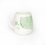 Color-in mug featuring US golf courses, by Trouvaille, with detailed golf course illustrations ready for coloring.