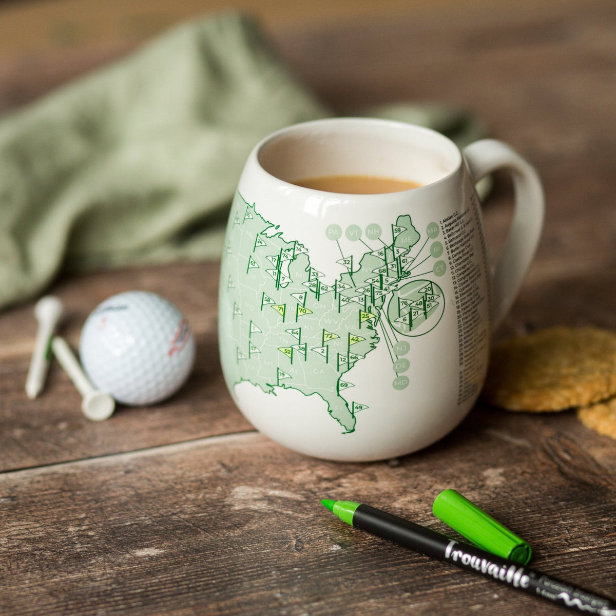 Trouvaille US Golf Courses color-in mug featuring a detailed golf course illustration on a white ceramic mug.