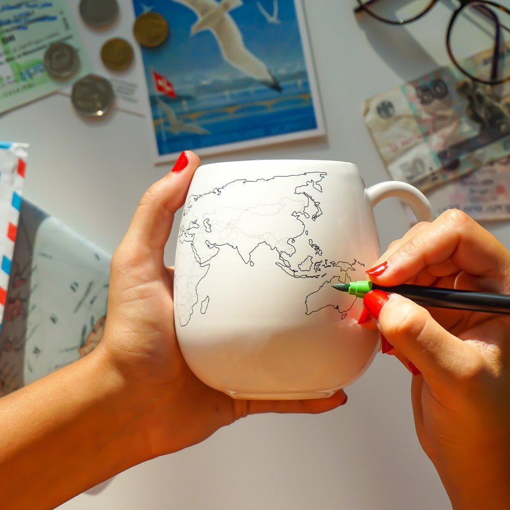 Trouvaille Colour-In Mug featuring a world map design, perfect for travel enthusiasts and adventurers.