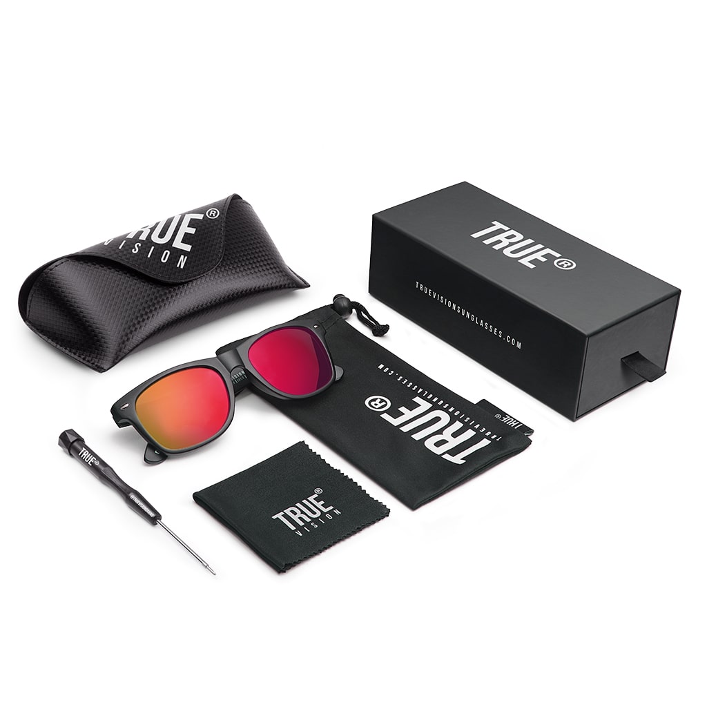 Polarised sunglasses with emerald green lenses from True Vision Brand, shown with accessories for outdoor use.