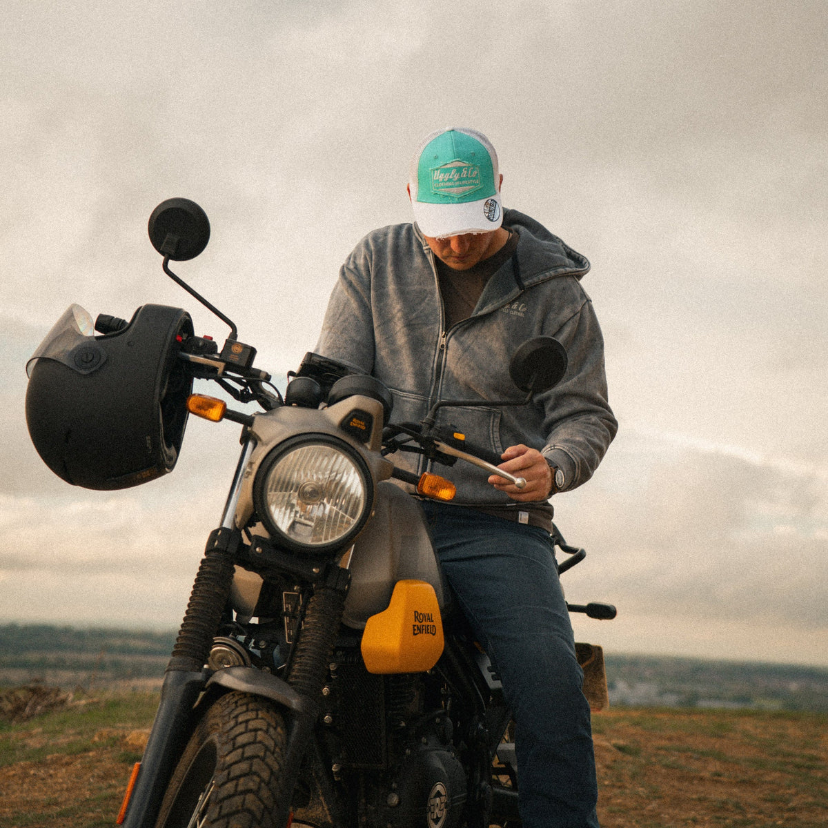 Turquoise and white diamond-patterned Uggly and Co trucker cap featuring a classic mesh back and adjustable strap for a casual look.