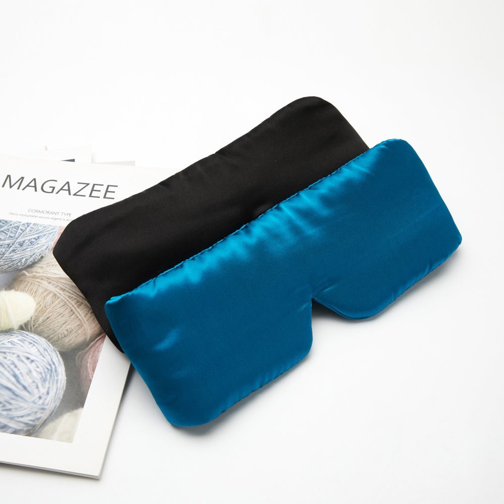 Black silk sleep mask from DREAMSILK with a smooth, luxurious texture and contoured design for comfortable, restful sleep.