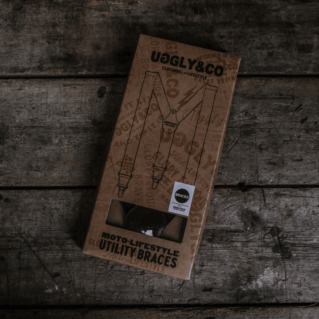 Black utility braces by Uggly and Co with adjustable straps and metal clips, designed as versatile accessories for everyday wear.