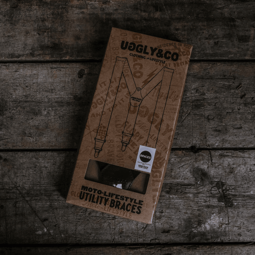 Black utility braces by Uggly and Co with adjustable straps and metal clips, designed as versatile accessories for everyday wear.