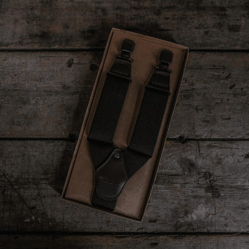Black utility braces from Uggly and Co, featuring durable straps and metal buckle closures, designed for motorcycle accessories.