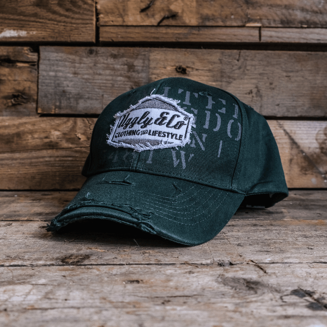 Green Uggly and Co aviation diamond trucker hat, weathered baseball cap with mesh back and adjustable strap.
