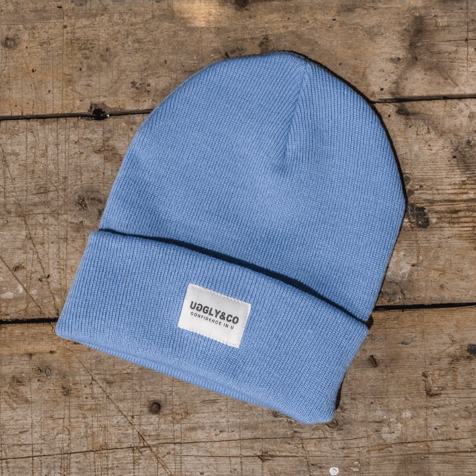 Blue Uggly and Co beanie hat with a cozy knit texture, perfect for casual winter wear.
