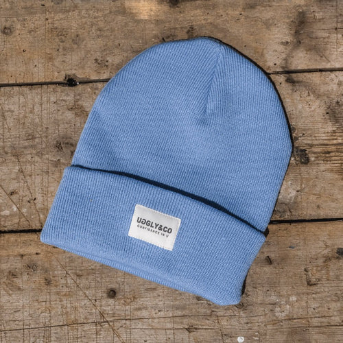 Blue Uggly and Co beanie hat with a cozy knit texture, perfect for casual winter wear.