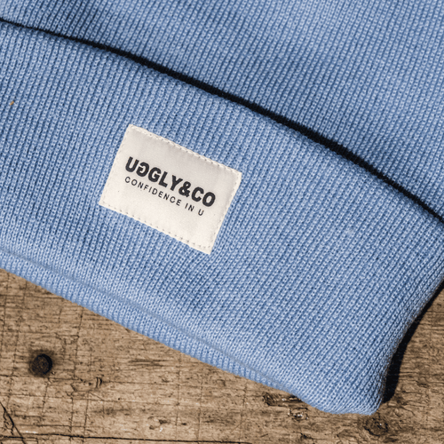 Vintage-style blue beanie by Uggly and Co, showcasing a cozy knit design perfect for cold weather.