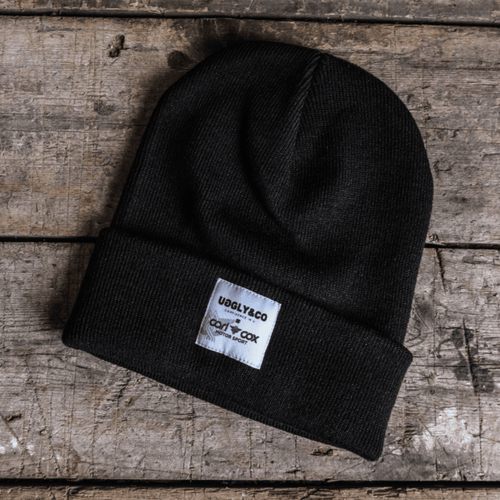 Uggly and Co Carl Cox Icon Beanie, black knit hat with bold logo, casual winter accessory for cold weather.