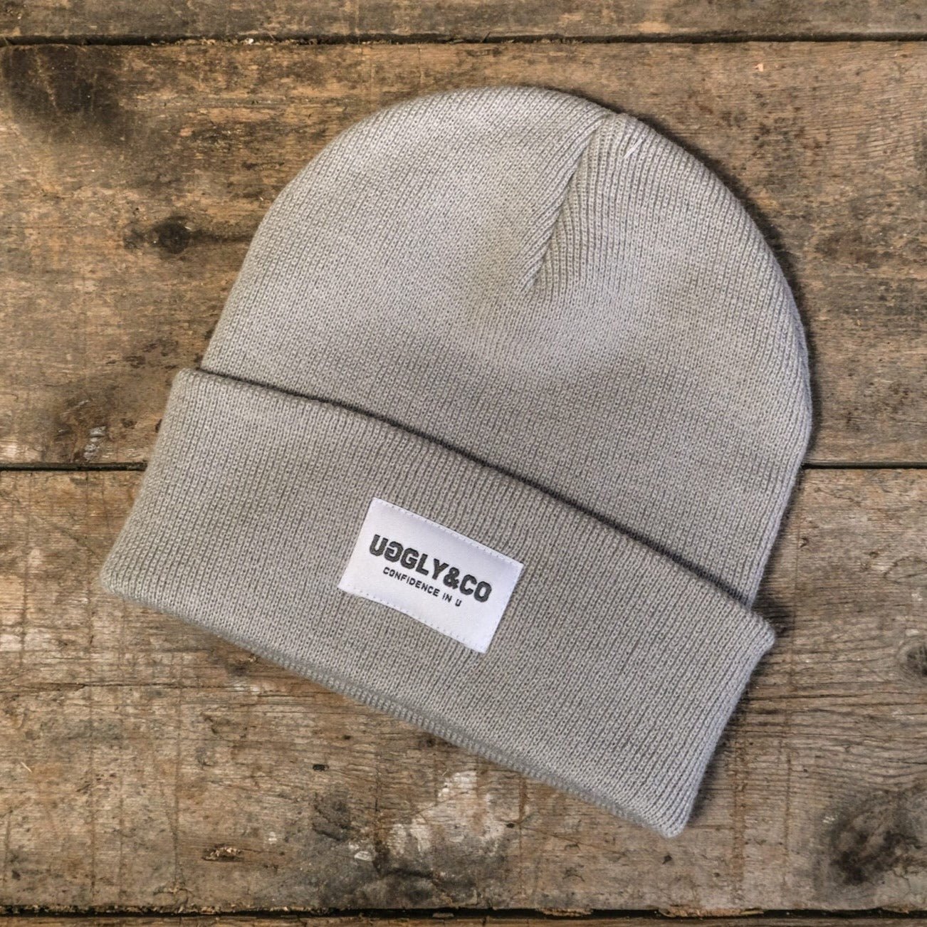 Grey Uggly and Co beanie showing a soft knit fabric and folded brim, perfect for casual winter wear.
