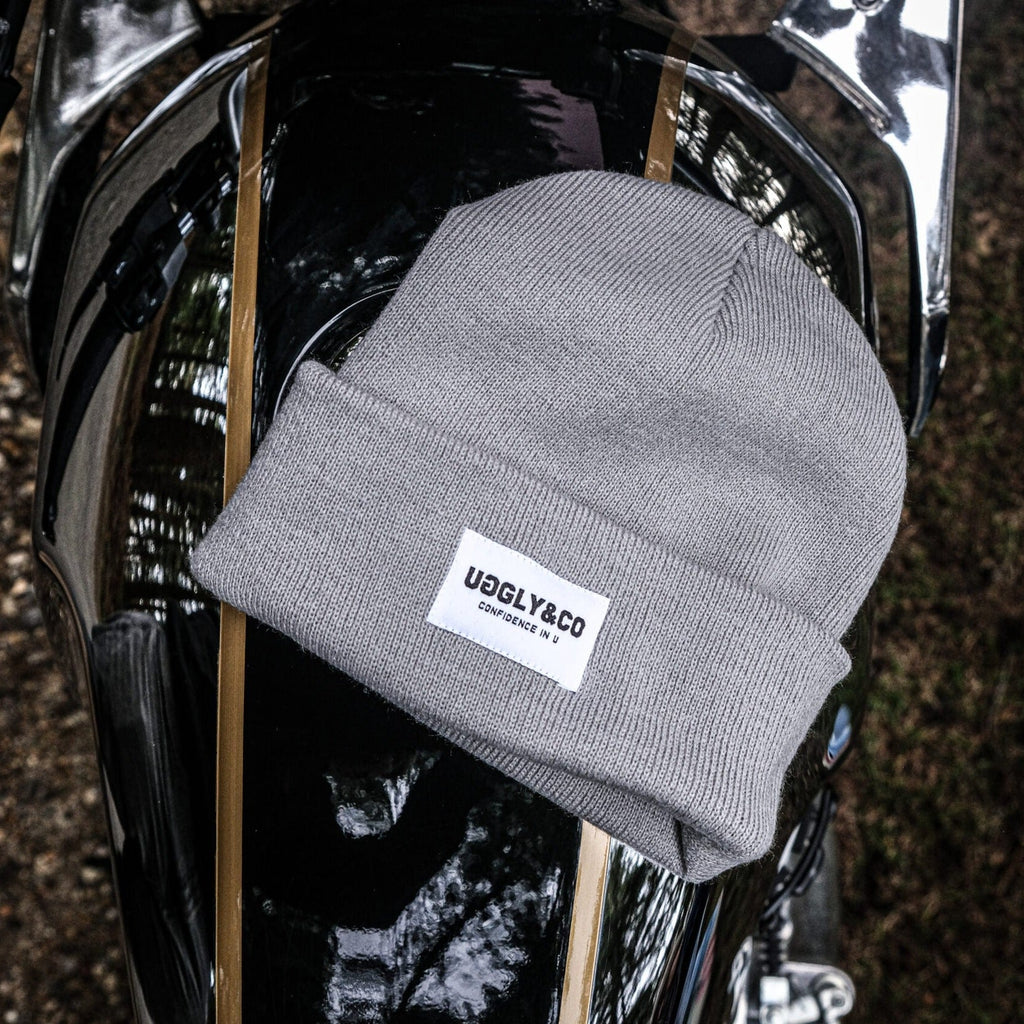 Grey Uggly and Co beanie featuring a snug knit design, perfect for cold weather and casual winter outfits.
