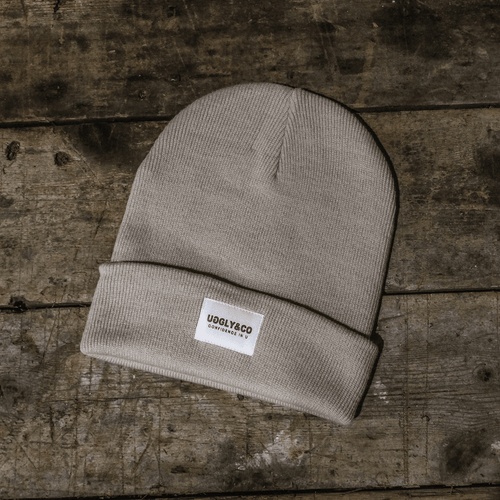 Oatmeal grey beanie by Uggly and Co, soft knit hat with a snug fit, ideal for cold weather and casual style.
