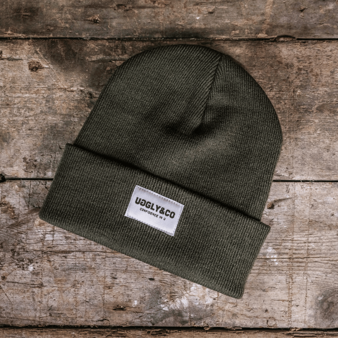Vintage olive Uggly and Co beanie made of soft knit fabric with a cozy folded brim, perfect for cold weather.