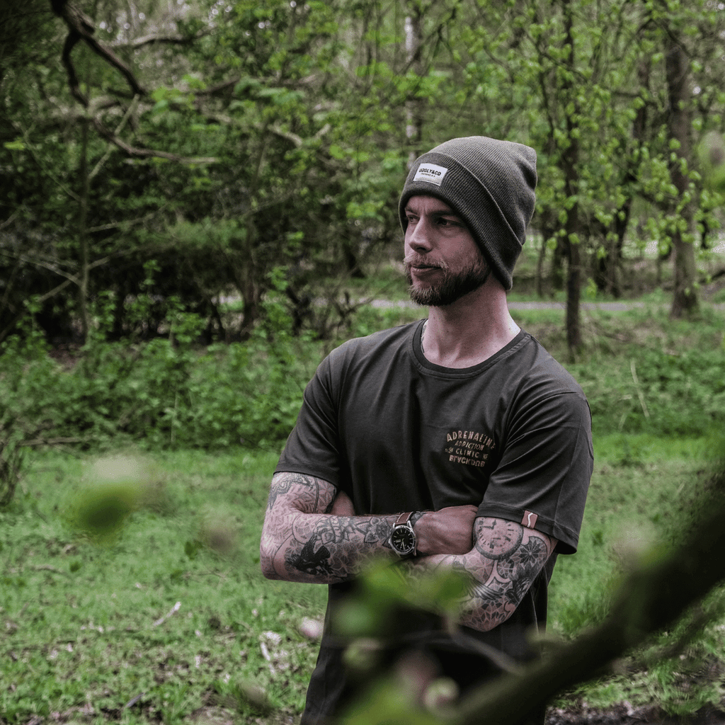 Olive Uggly and Co beanie hat made of soft knit fabric, featuring a snug fit and ribbed texture for cozy winter wear.