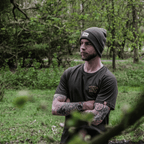 Olive Uggly and Co beanie hat made of soft knit fabric, featuring a snug fit and ribbed texture for cozy winter wear.