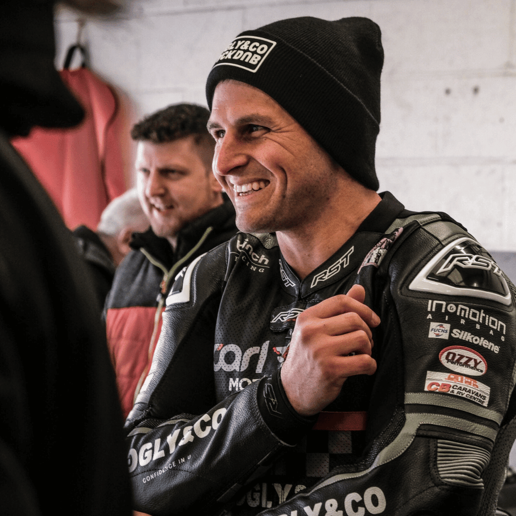 Black Uggly&Co beanie with The Black Dub Garage x Uggly&Co branding, knitted style, worn on a model.