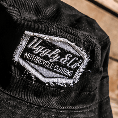 Black Diamond Bucket Hat by Uggly and Co featuring a classic wide-brim design in black fabric.