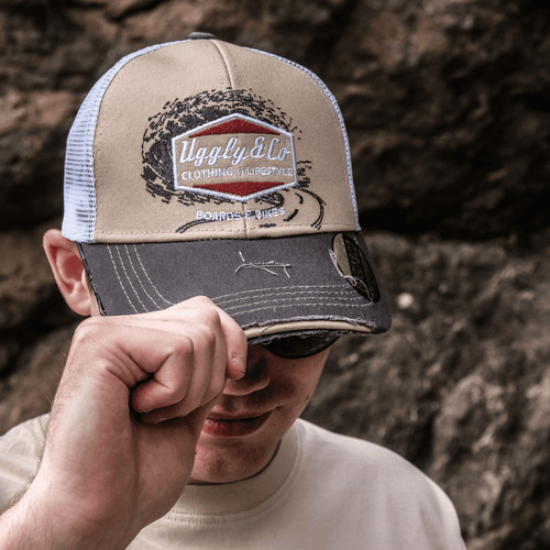 Beige surf diamond trucker cap for men by Uggly and Co, featuring a classic trucker hat style with a mesh back and diamond logo design.