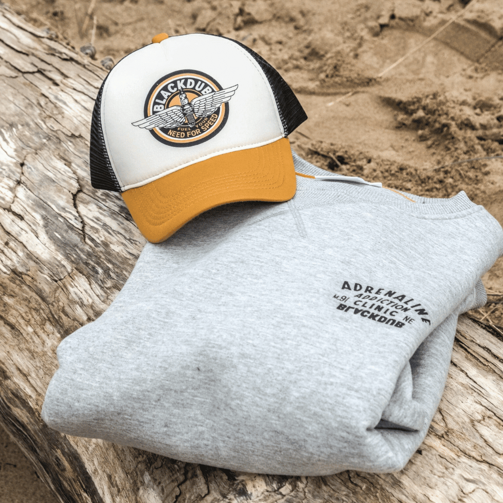 Black Dub Garage Circle Wings Uggly and Co trucker cap with embroidered wing and circle design on front, adjustable mesh back