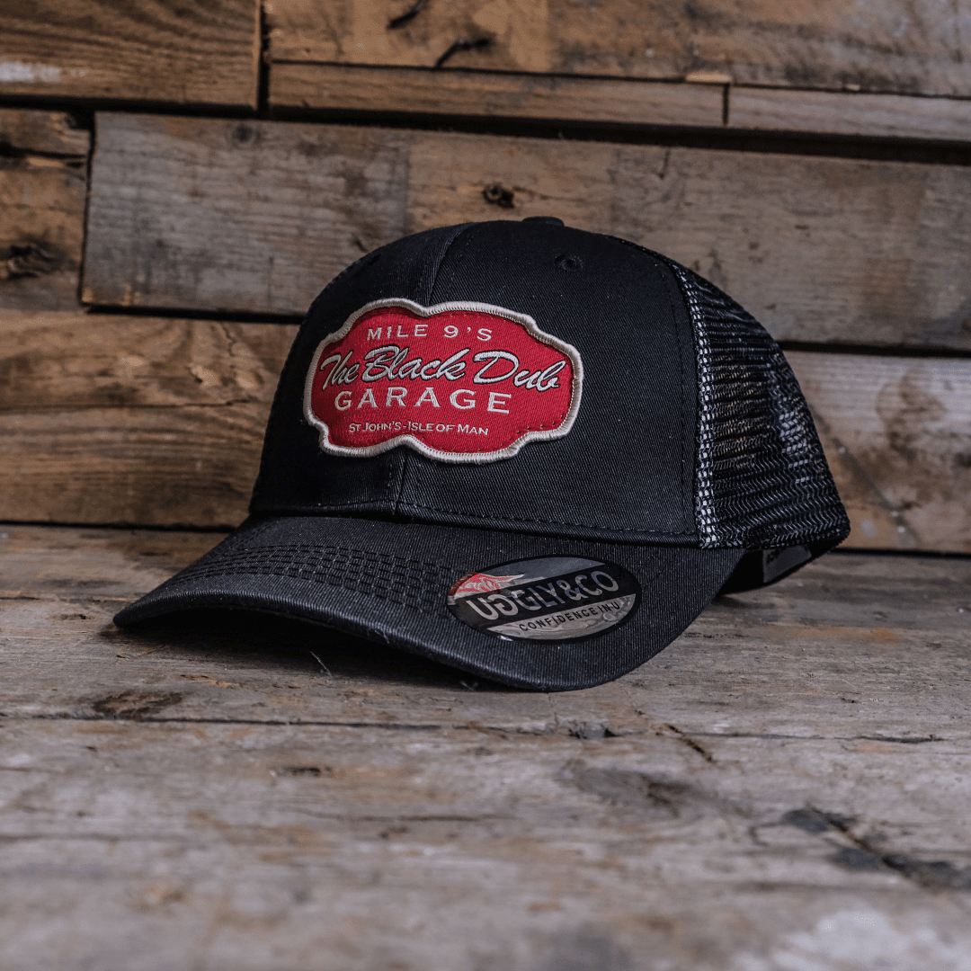 Black Dub Garage Trucker Hat by Uggly and Co featuring a vintage-style trucker cap design with mesh back and adjustable strap.