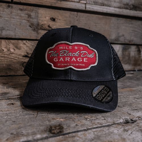 Black Dub Garage Trucker Hat by Uggly and Co featuring a classic trucker cap design with mesh back and embroidered front panel.