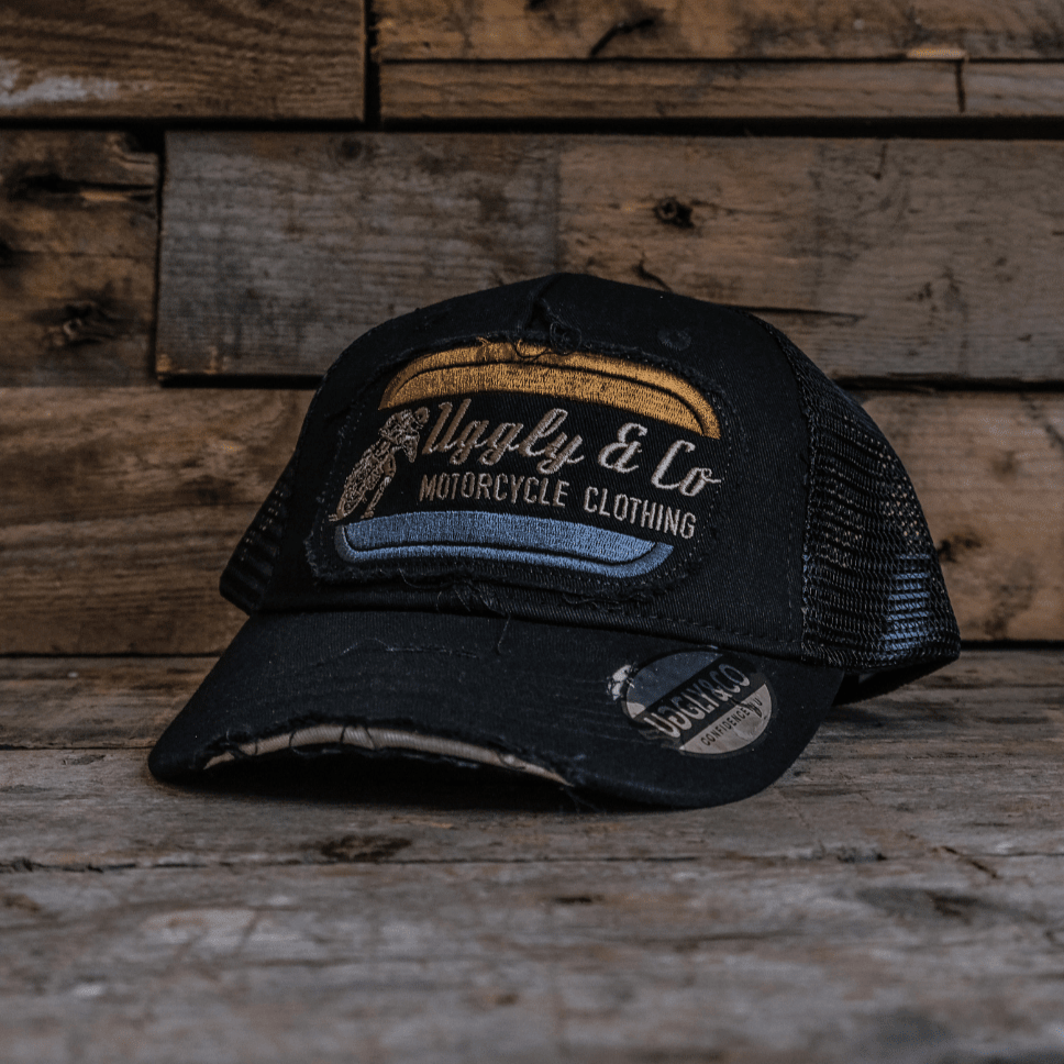 Black flat track trucker hat by Uggly and Co featuring a curved brim and mesh back for a casual, racing-inspired look.