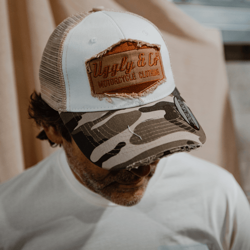 Uggly and Co camo diamond trucker hat with mesh back and curved brim, featuring a diamond pattern design.