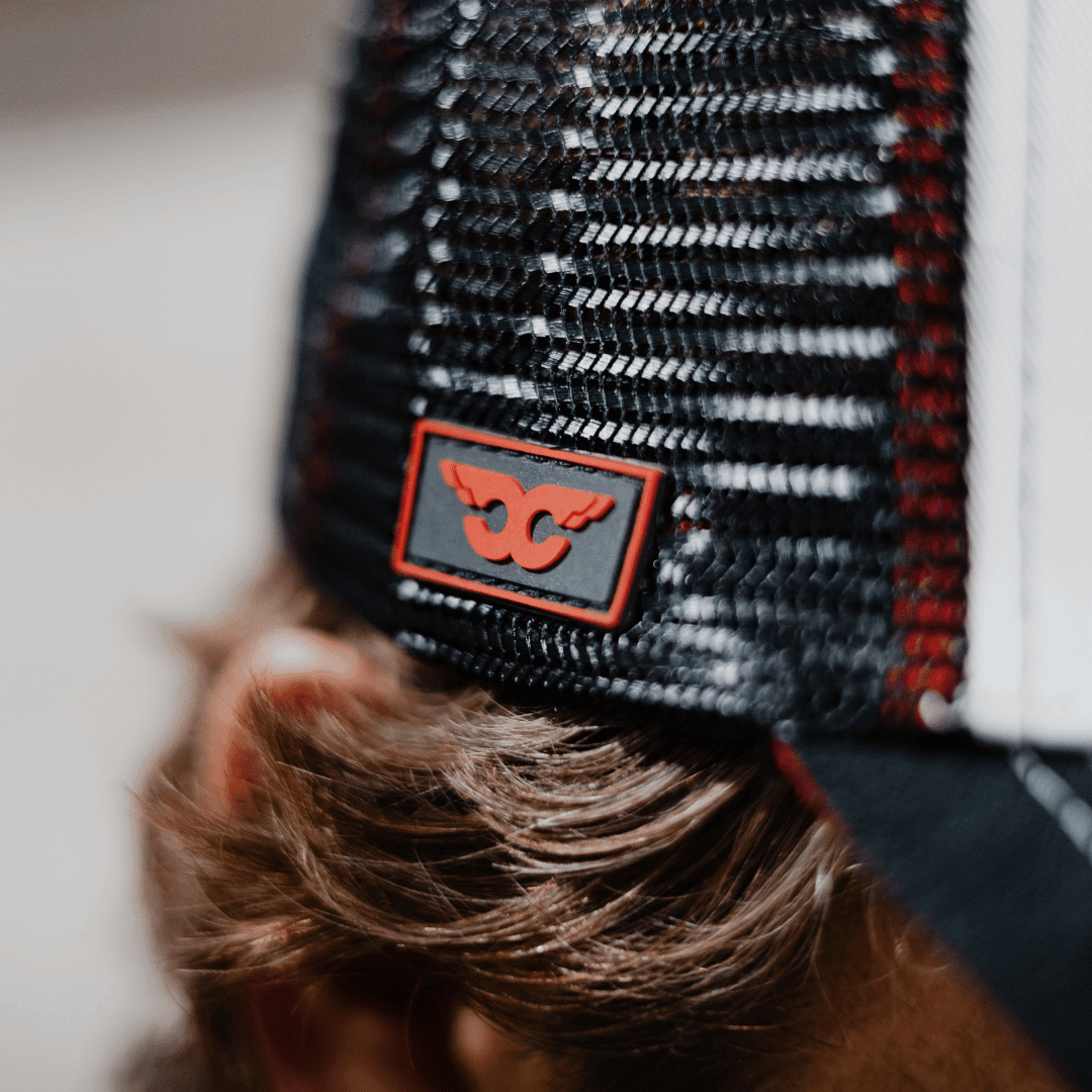 Uggly and Co Carl Cox Icon Trucker Hat, black trucker cap with bold graphic design, adjustable mesh back, casual style.