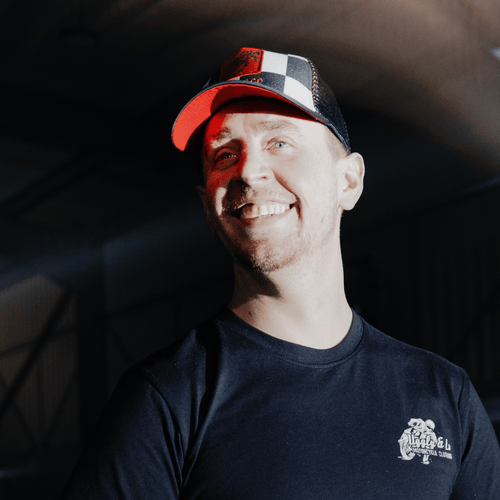 Uggly and Co chequered flat track trucker hat with mesh back and curved brim, stylish casual headwear for men and women.