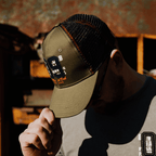 Green Uggly and Co trucker cap with "09" logo, featuring a mesh back and adjustable strap, casual headwear for everyday wear.