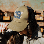Green Uggly and Co. Parts & Spares '09' trucker hat with mesh back and adjustable strap, casual cap for everyday wear.