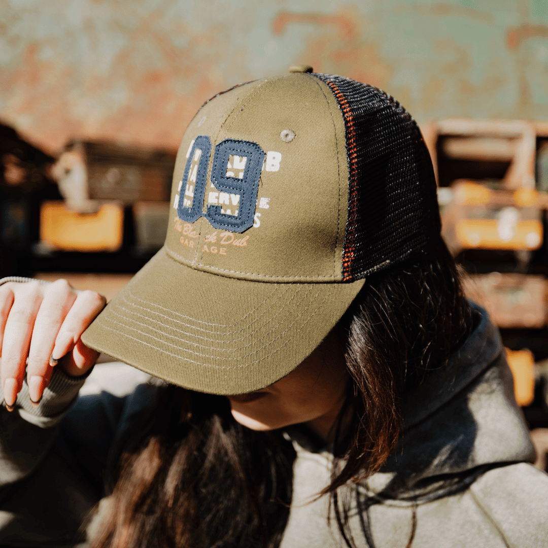 Green Uggly and Co. Parts & Spares '09' trucker hat with mesh back and adjustable strap, casual cap for everyday wear.