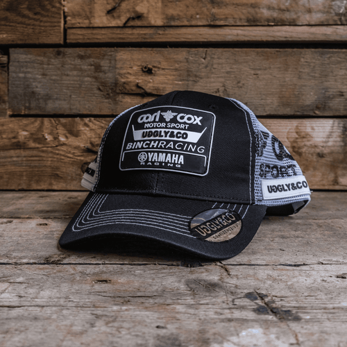Official Carl Cox Motorsport Trucker Hat by Uggly and Co featuring a classic trucker cap design with bold branding.