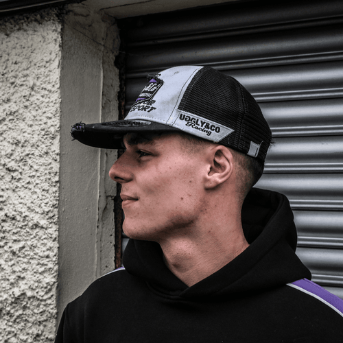 Purple diamond trucker hat by Uggly and Co featuring JDM Racing branding, with mesh back and curved brim.