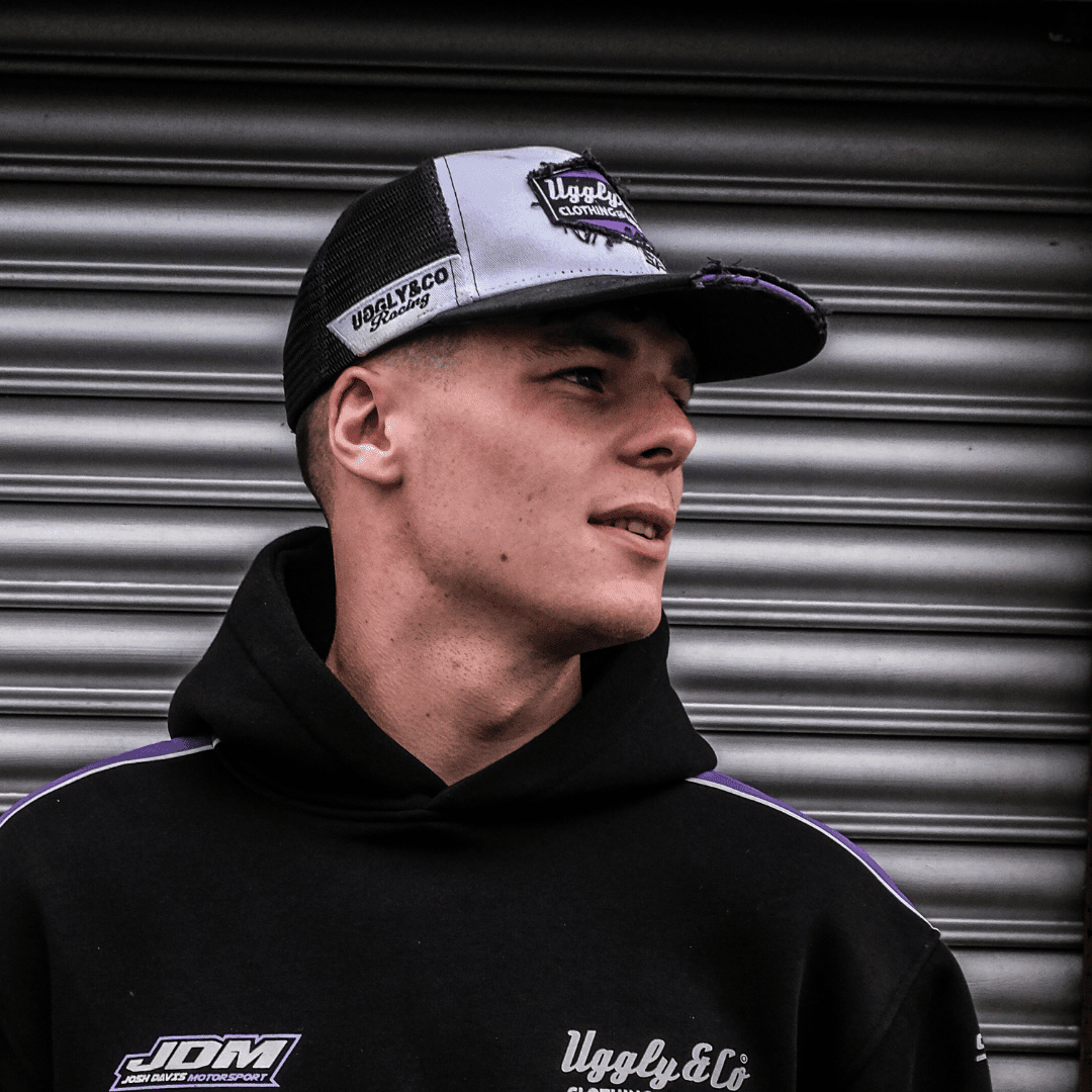 Purple diamond trucker cap by Uggly and Co featuring JDM Racing branding, with mesh back and adjustable snap closure.