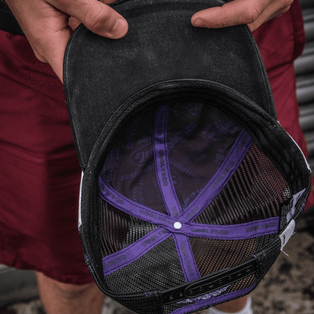 Purple diamond design trucker cap by Uggly and Co with JDM Racing branding, adjustable mesh back and curved brim.