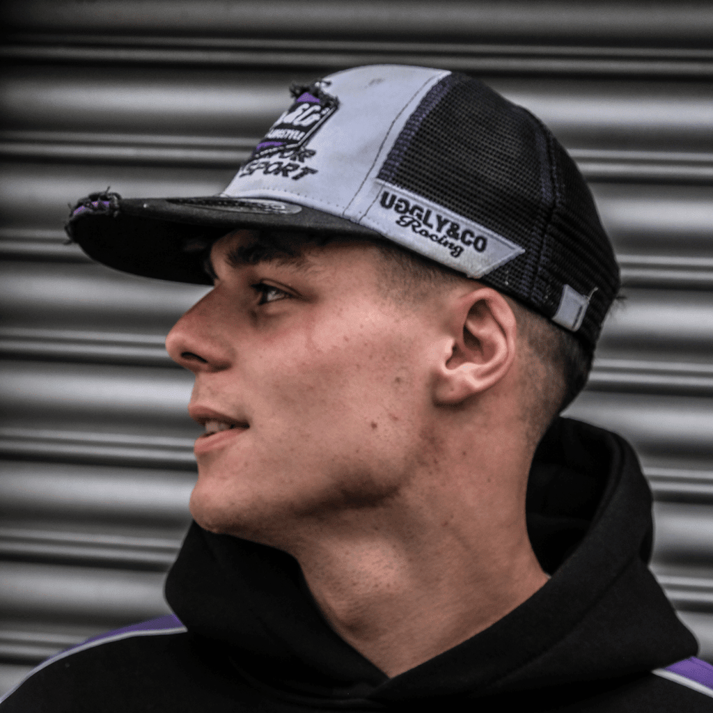 Purple diamond trucker cap by Uggly and Co featuring JDM Racing branding, with mesh back and adjustable snap closure.